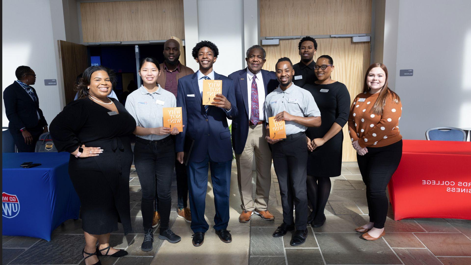 Larry and students holding book