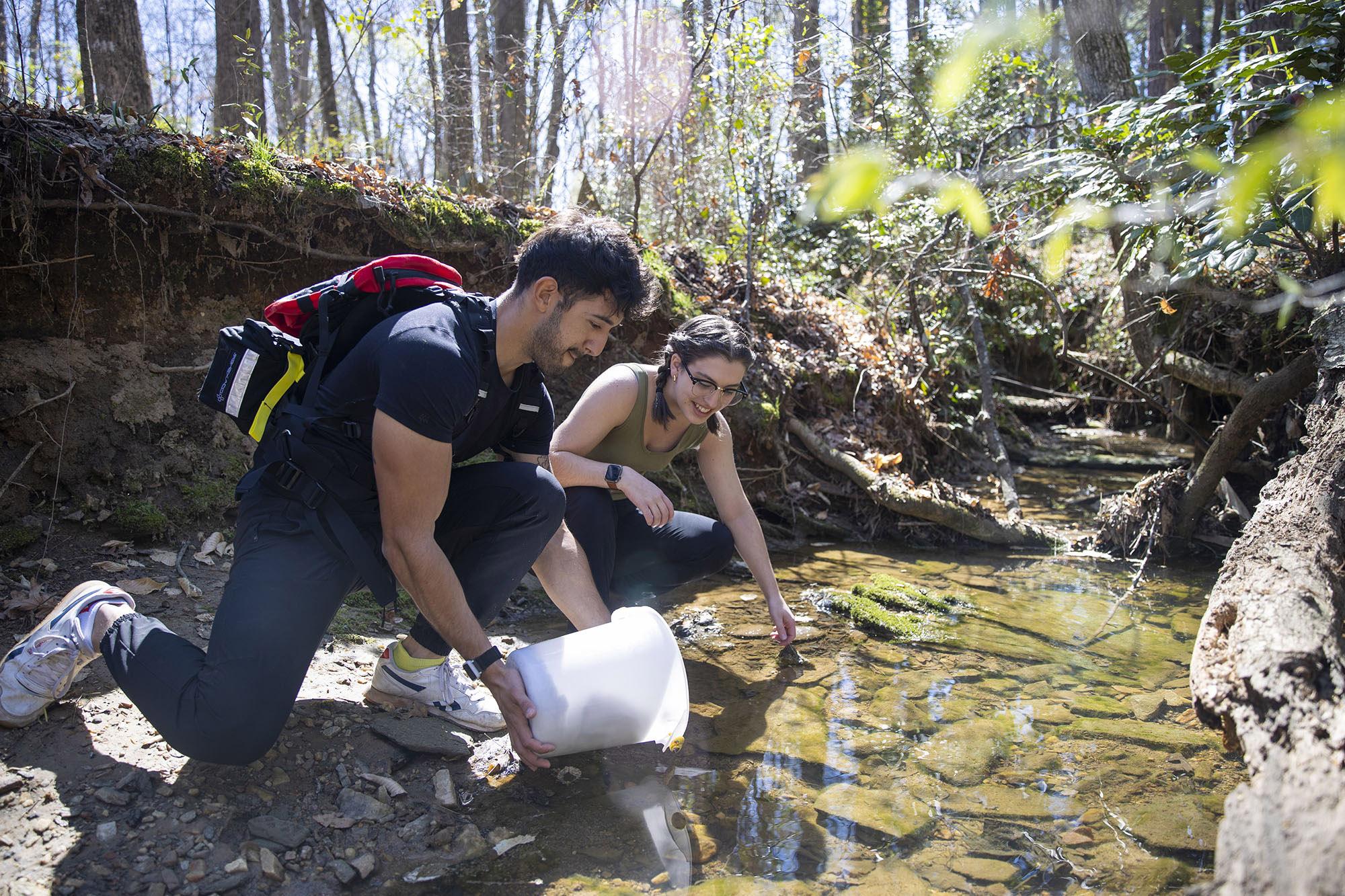 Students working in a creek